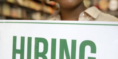 person with hiring sign